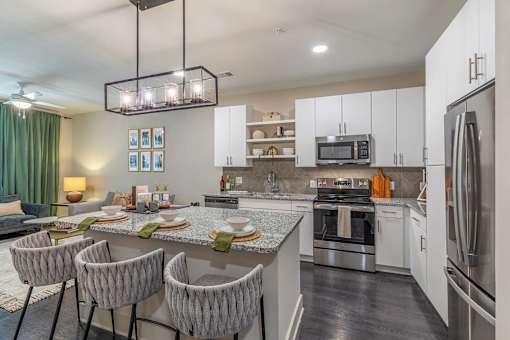 A modern kitchen with a dining table set for four.