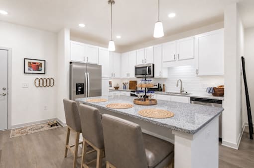 A kitchen with a granite countertop and a refrigerator.