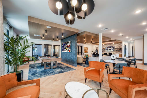 a lobby with couches chairs and tables and a bar
