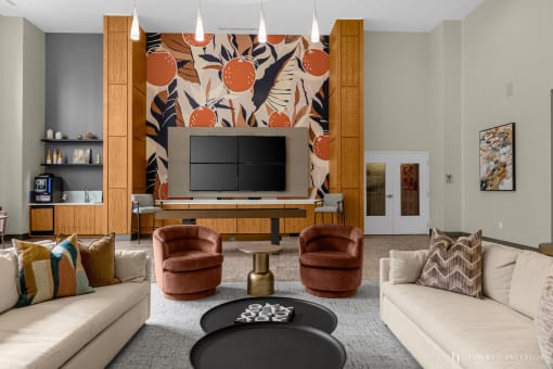 a living room with couches and chairs and a television