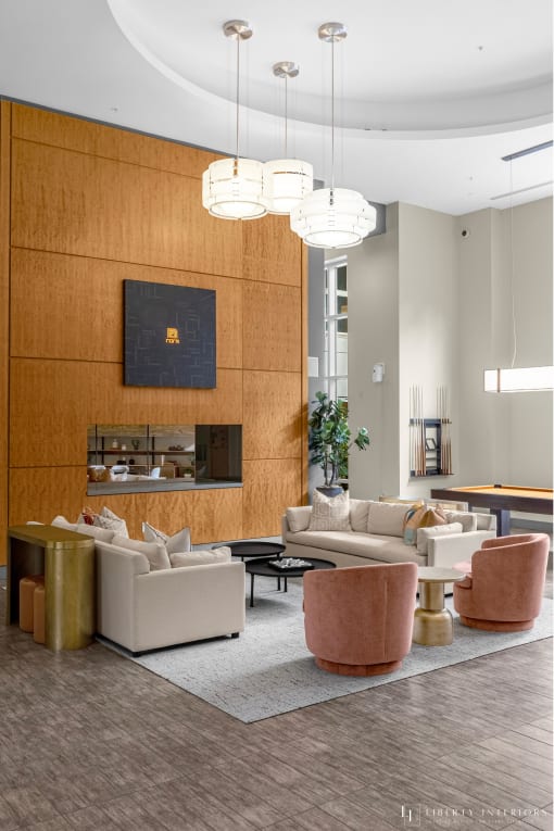 a living room with couches and chairs and a fireplace