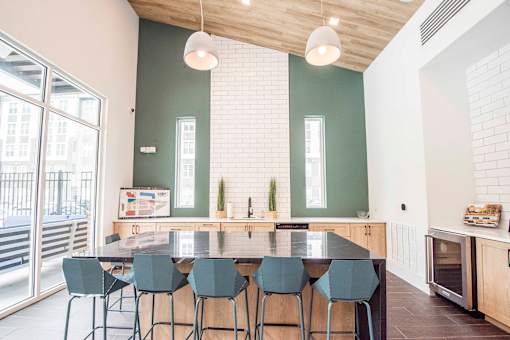 A kitchen with a table and chairs.