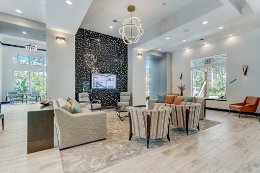 A modern living room with a large sofa set and a television.