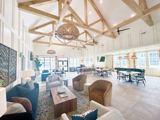 A large, open-plan living area with a piano and multiple seating options.