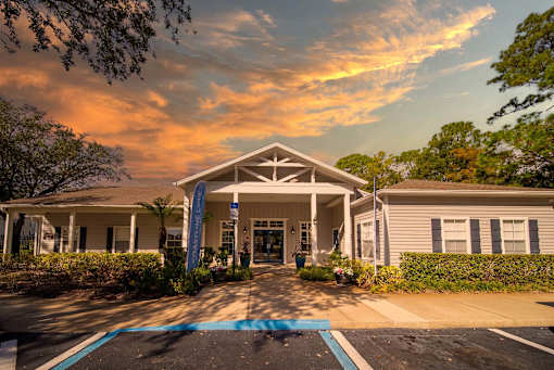 A building with a covered walkway and a blue banner on the left side.