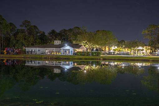 A building is reflected in the water at night.
