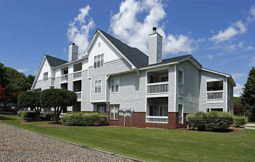 A large house with a grey exterior and a balcony.