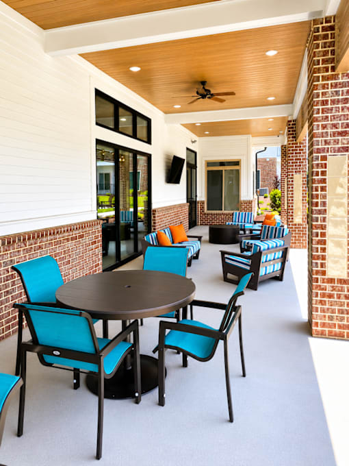 A patio with a table and chairs.