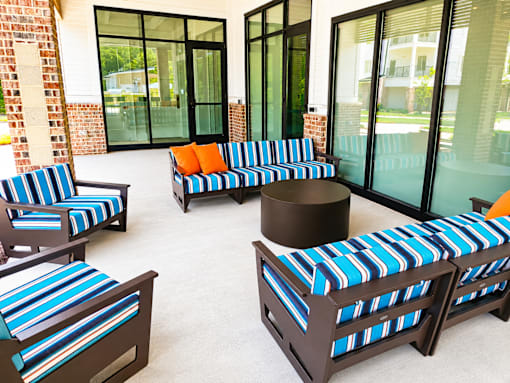 A set of outdoor furniture with blue and white striped cushions.