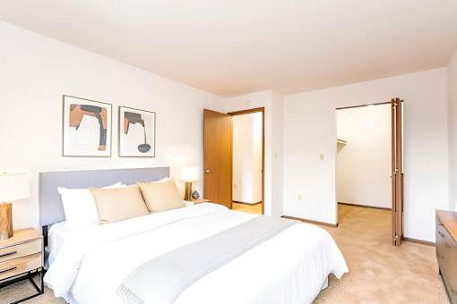 A bedroom with a large bed and two framed pictures on the wall at Winchell Way Apartment , Kalamazoo, 49008