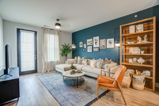 a living room with a blue accent wall and a white couch