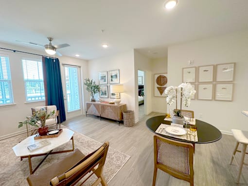 A living room with a dining table and chairs.