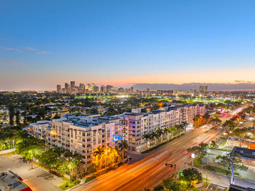 an aerial view of a city at sunset with traffic and buildings