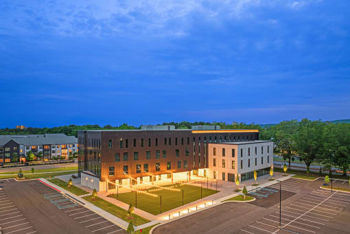 an aerial view of a building at night with lights