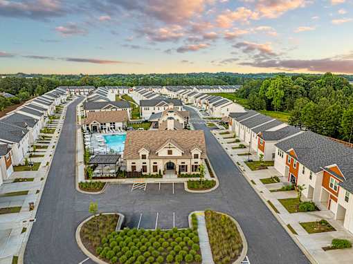 an aerial view of a neighborhood with houses and a pool
