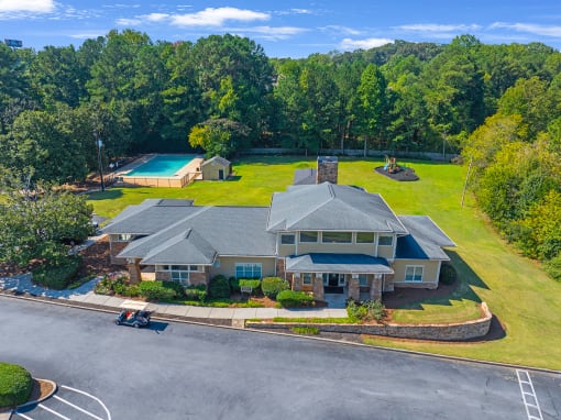 a large house with a yard and a swimming pool
