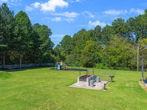 a park with a playground and a fire pit
