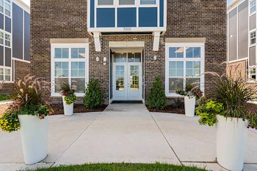 The front of a building with a glass door and windows.