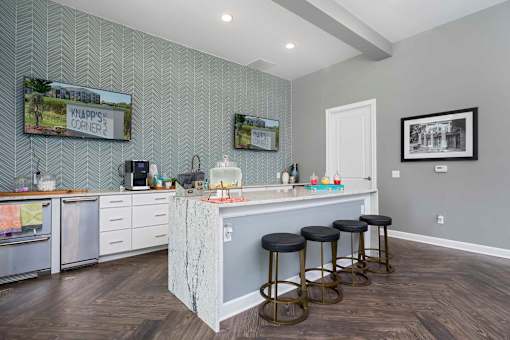 A kitchen with a bar area and stools.