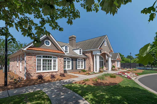 A house with a brick facade and a large front porch.