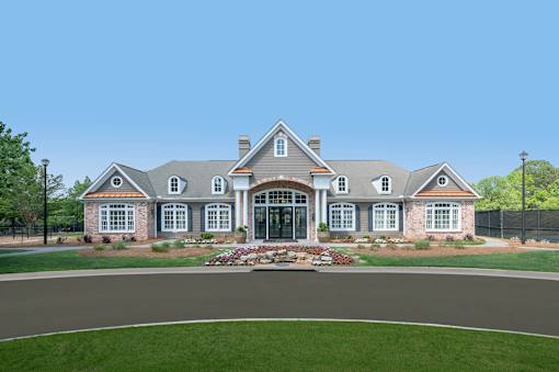 A large, well-maintained house with a landscaped front yard.