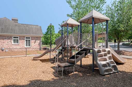 A playground with a slide and a gazebo.