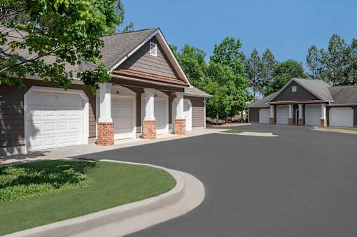 A house with a driveway and garage doors.
