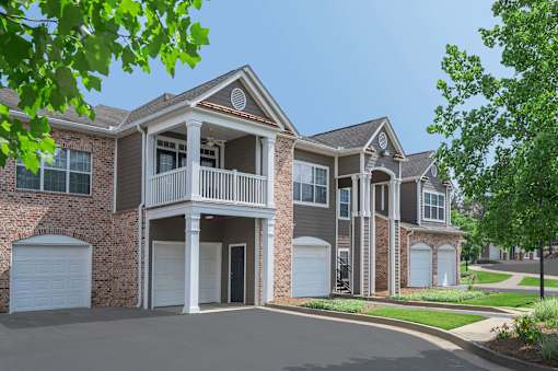 A two-story house with a balcony on the second floor.