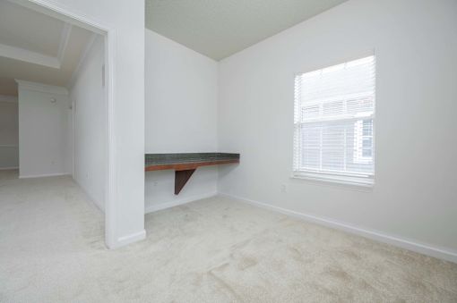 A room with a window and a bench.
