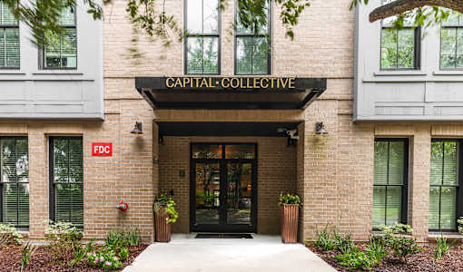 The front of a building with the words "Capital Collective" on the top.