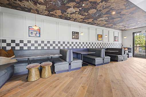 A room with a checkered floor and a ceiling with a floral pattern.