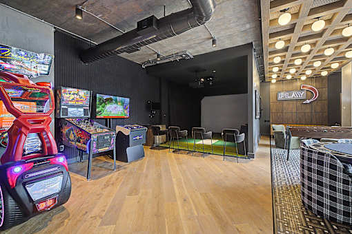 A room with a red arcade machine and a sign that says "iPlay".