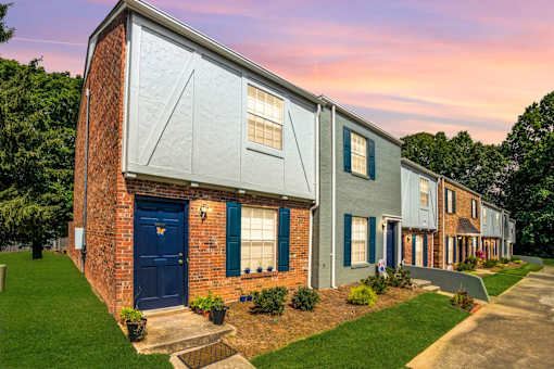 A row of houses with blue doors and windows.