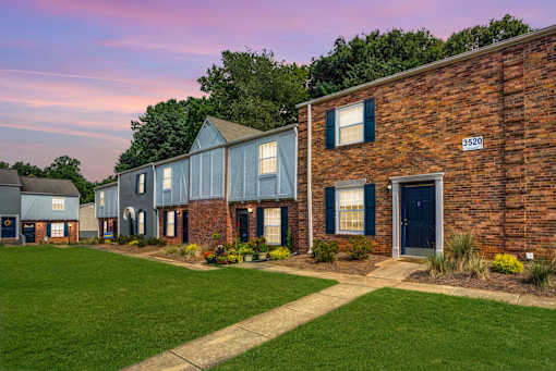 A row of houses with the number 3520 on the brick house.