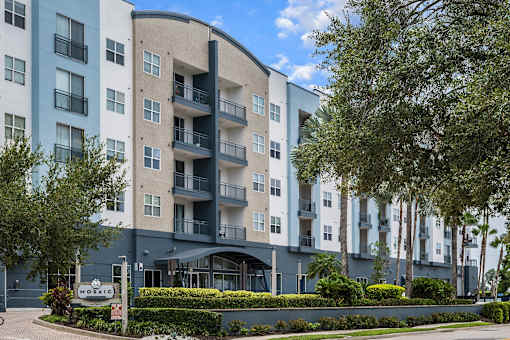 A modern apartment building with balconies and a sign that reads "HOSPITAL".