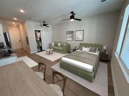 A bedroom with two beds and a ceiling fan.