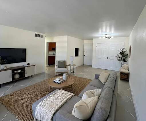 A living room with a grey couch and a coffee table.