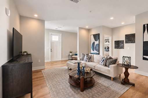 A living room with a white couch and a coffee table.