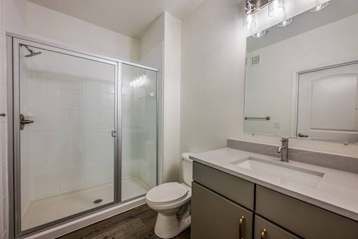 A bathroom with a toilet, sink, and shower.
