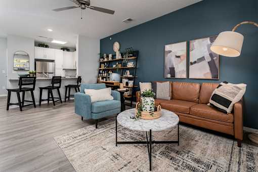 Alexandria, KY, Apartments with In-Unit Washer and Dryer - Elevation Apartment Homes - Modern Living Room With Leather Sofa, Round Coffee Table, And Wood Style Flooring.