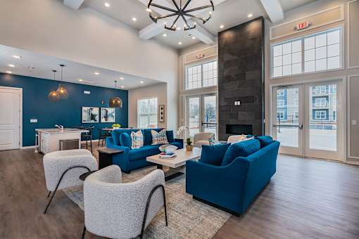 A living room with a blue couch and a fireplace.