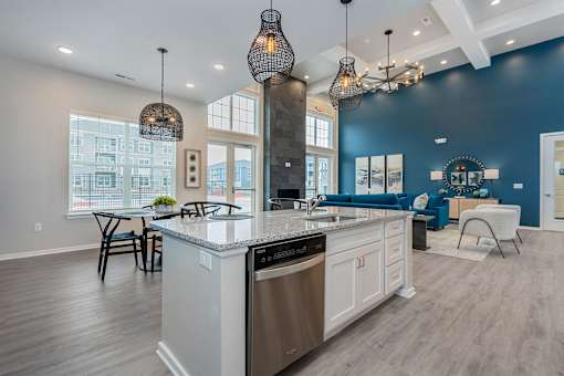 A modern kitchen with a large island and stainless steel appliances.