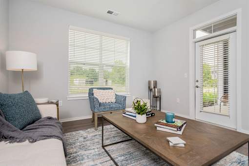 A living room with a couch, chair, and table.