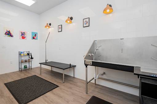 A room with a table, a bench, and a sink.