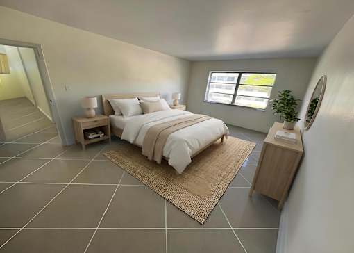 A bedroom with a large bed and a mirror on the side.