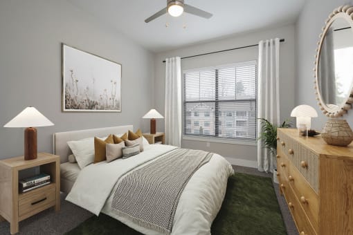 a bedroom with a large window and a ceiling fan