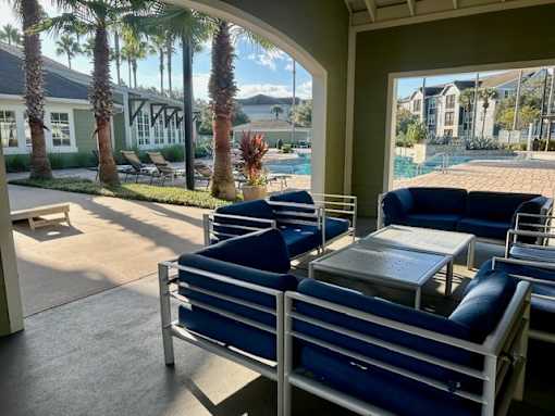 A patio with blue chairs and a table is shown.
