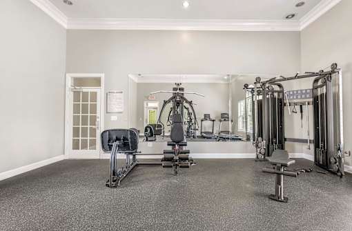 A spacious home gym with a variety of exercise equipment.