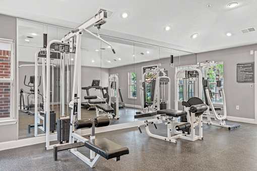 A gym with a variety of equipment including a leg press machine.