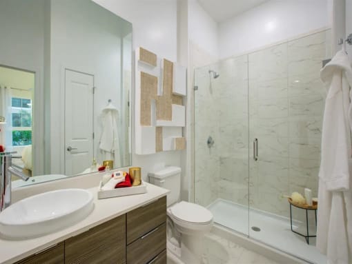 a bathroom with a sink toilet and shower at Altis Grand Central, Tampa, 33606